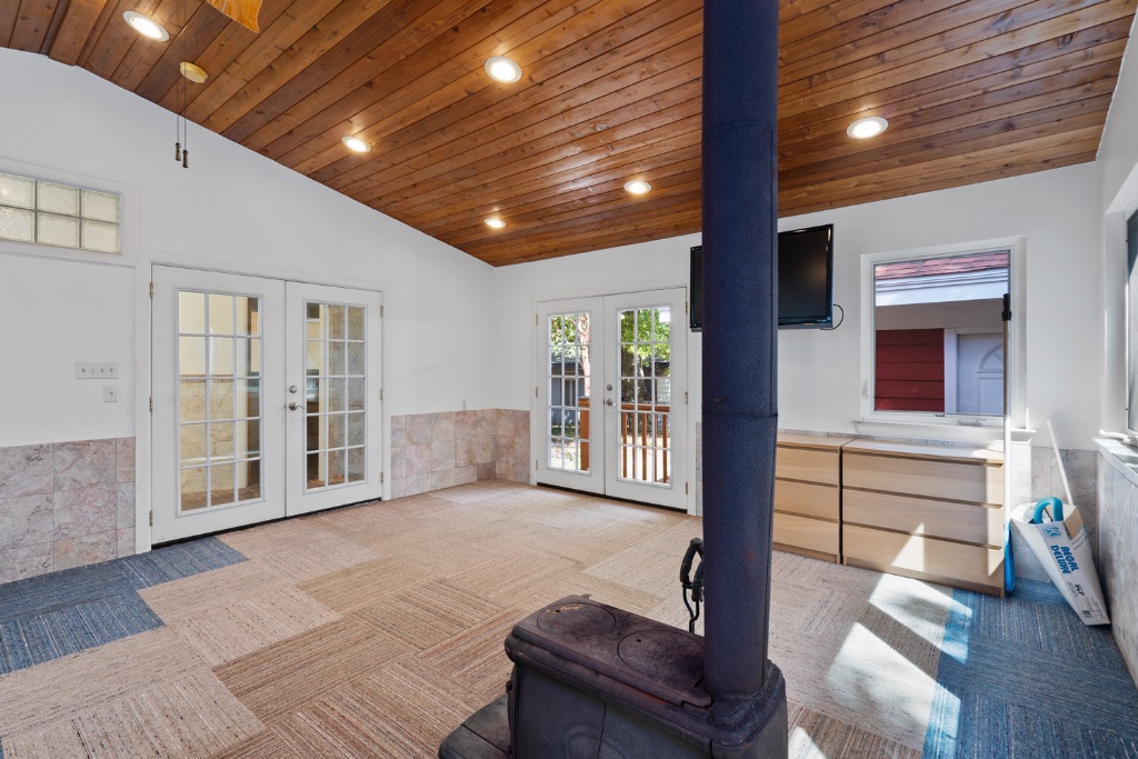1212 Bentwood Road Austin, TX 78722 - Photo 27 of 32 a spacious bedroom with a balcony a bed and a couch
