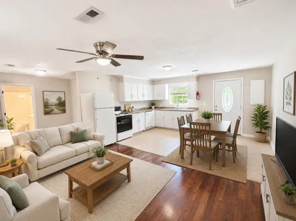 a living room with furniture kitchen view and a dining table
