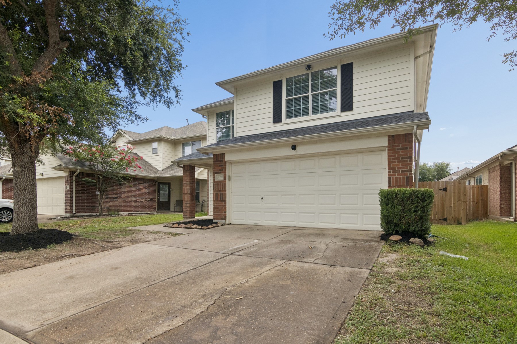 14211 Brunswick Point Lane Houston, TX 77047 - Photo 1 of 17 This is a two-story home featuring a double garage, neutral exterior with brick accents, and mature trees and shrubs.