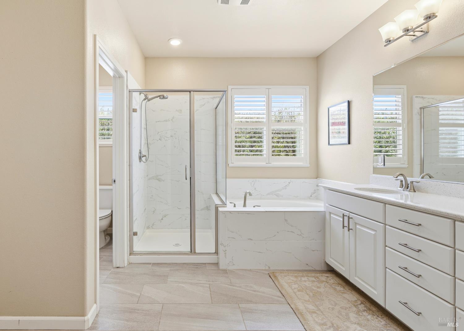 5533 Kennedy Place Rohnert Park, CA 94928 - Photo 26 of 63 a spacious bathroom with a mirror a shower and a bathtub