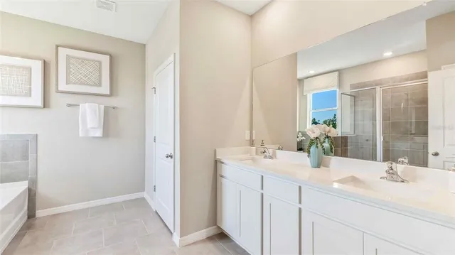 a bathroom with a double vanity sink mirror and