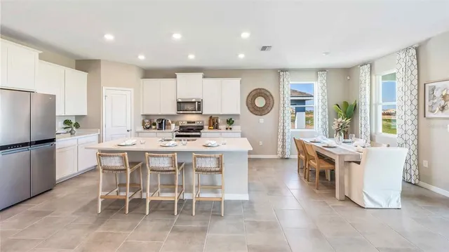 a large kitchen with a table and chairs in it
