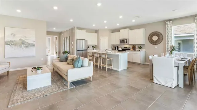 a living room with furniture a clock and a window