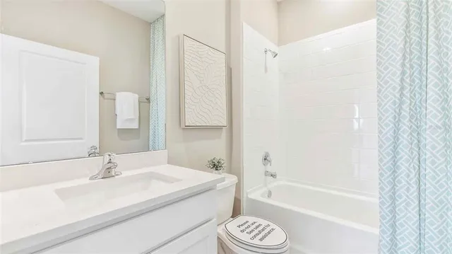 a bathroom with a granite countertop sink a toilet and bathtub