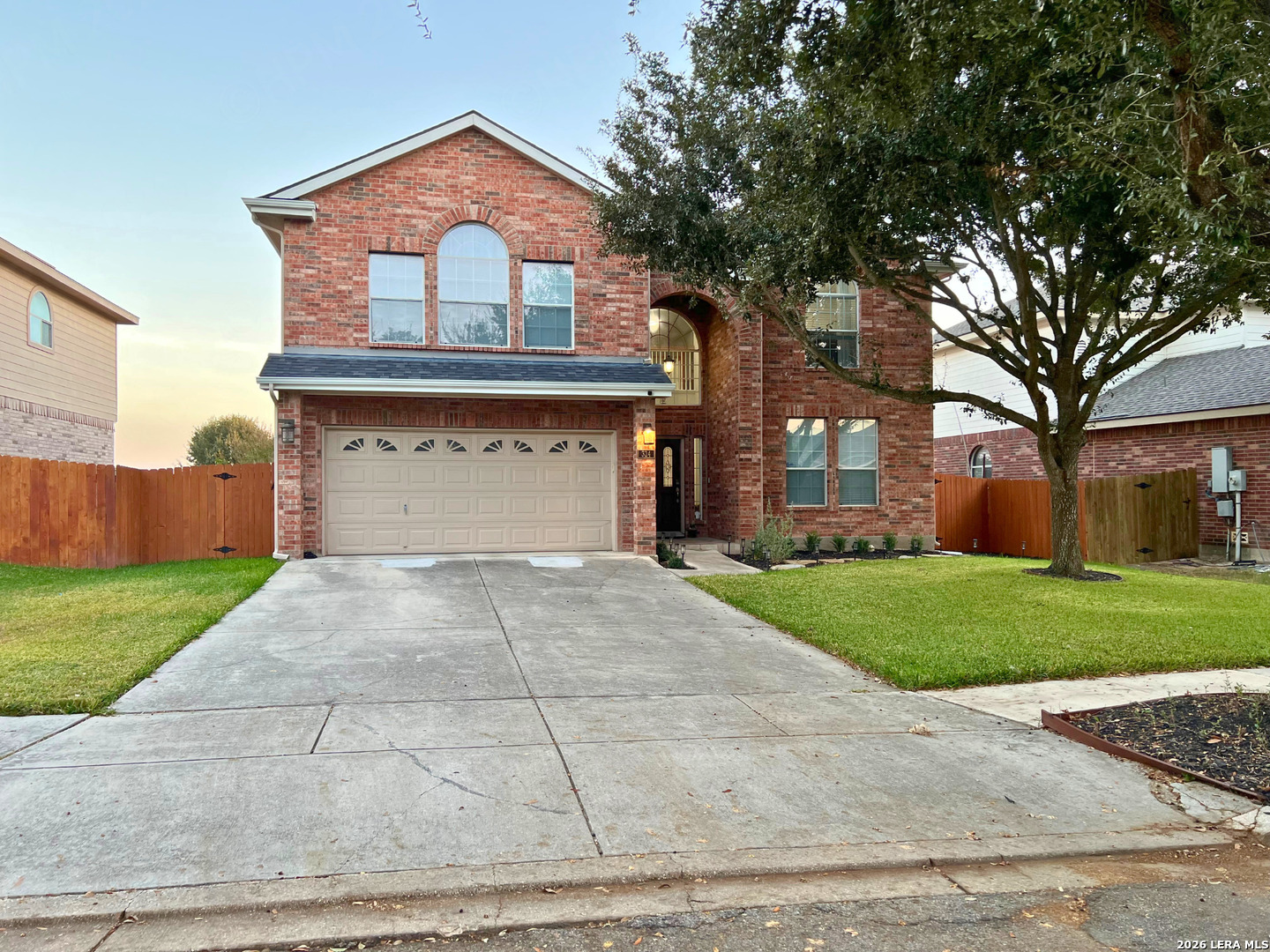 324 Willow Loop Cibolo, TX 78108 - Photo 2 of 20 a front view of a house with a yard and garage