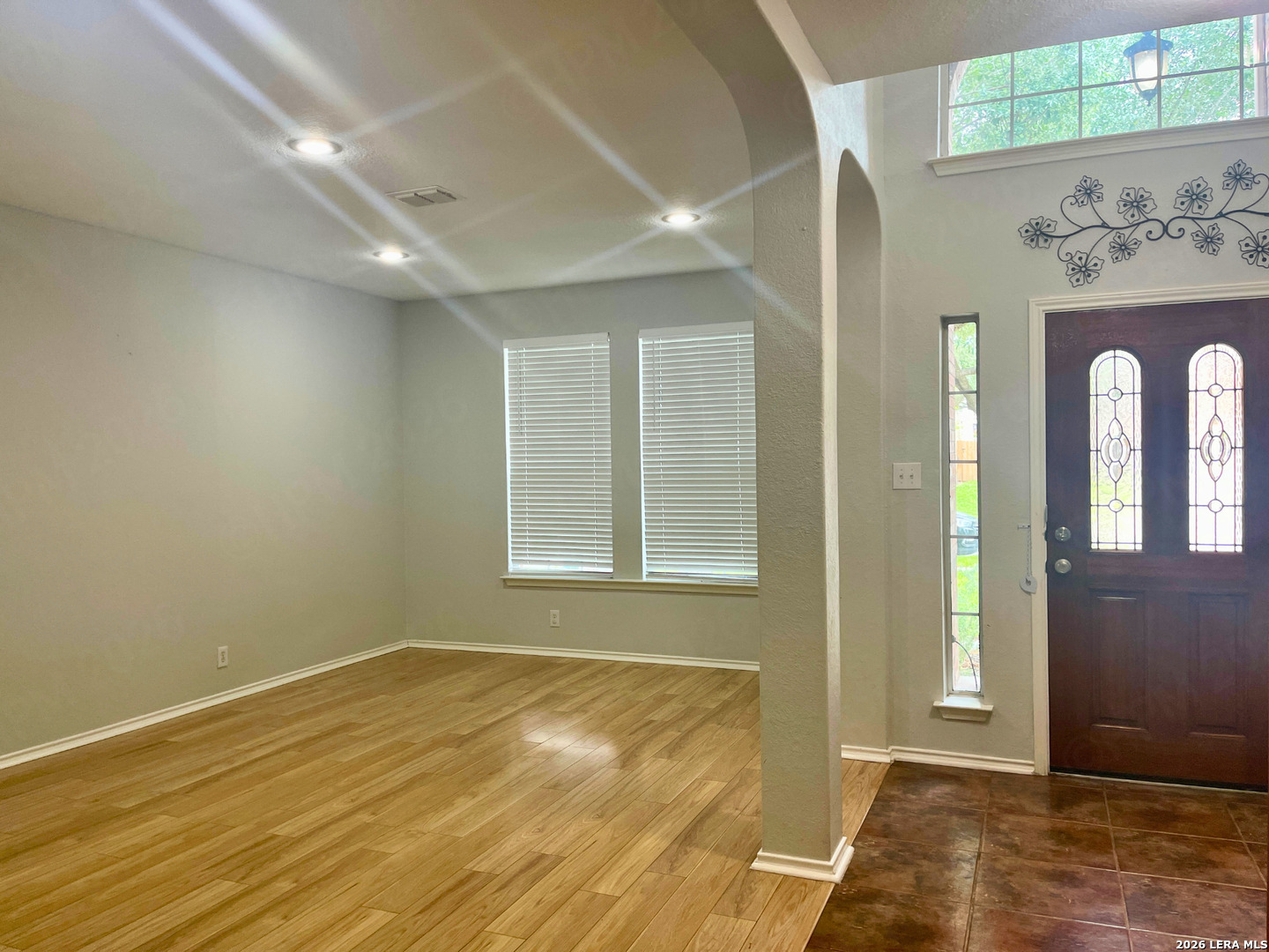 324 Willow Loop Cibolo, TX 78108 - Photo 4 of 20 an empty room with wooden floor and a window