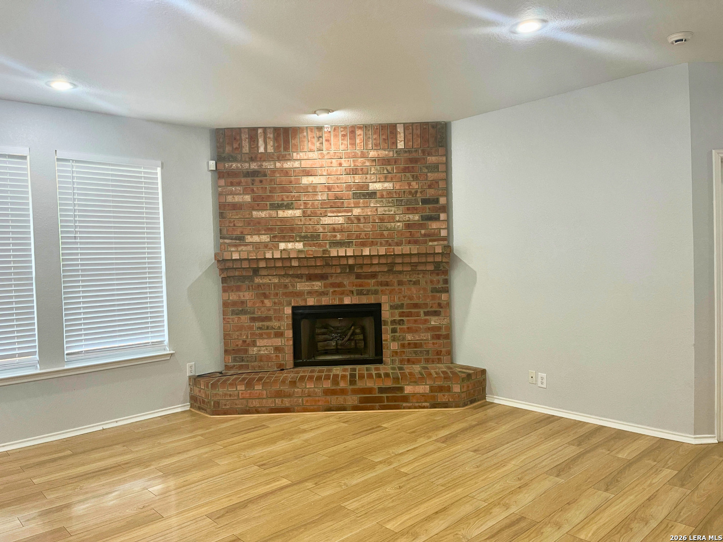 324 Willow Loop Cibolo, TX 78108 - Photo 6 of 20 a view of empty room with fireplace and wooden floor
