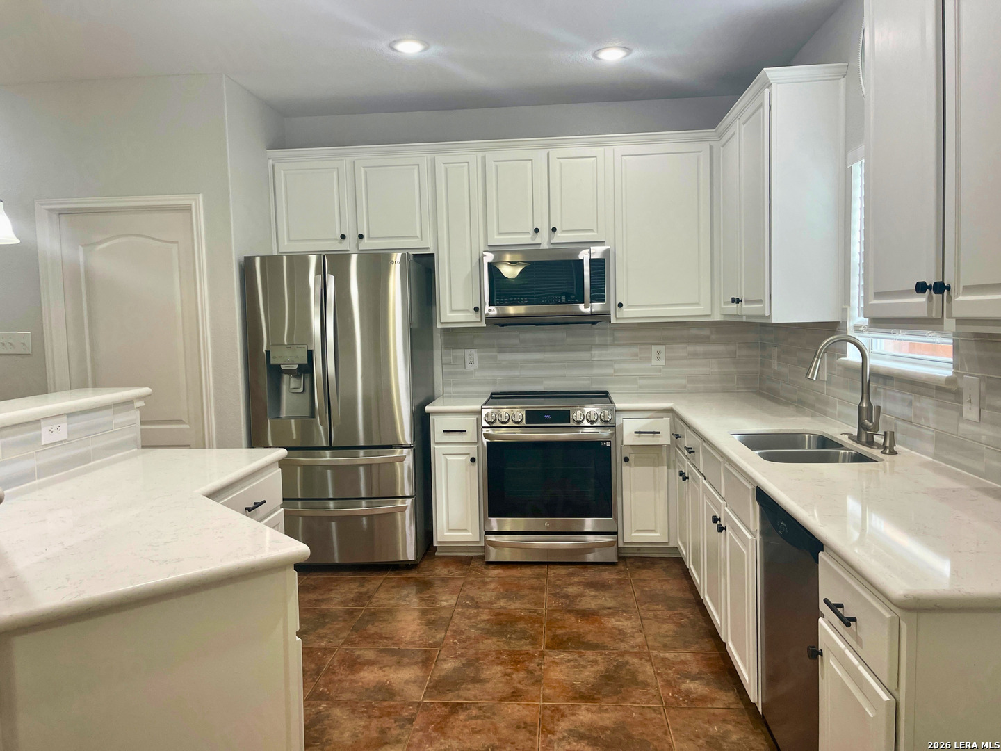 324 Willow Loop Cibolo, TX 78108 - Photo 10 of 20 a kitchen with stainless steel appliances a refrigerator stove and sink