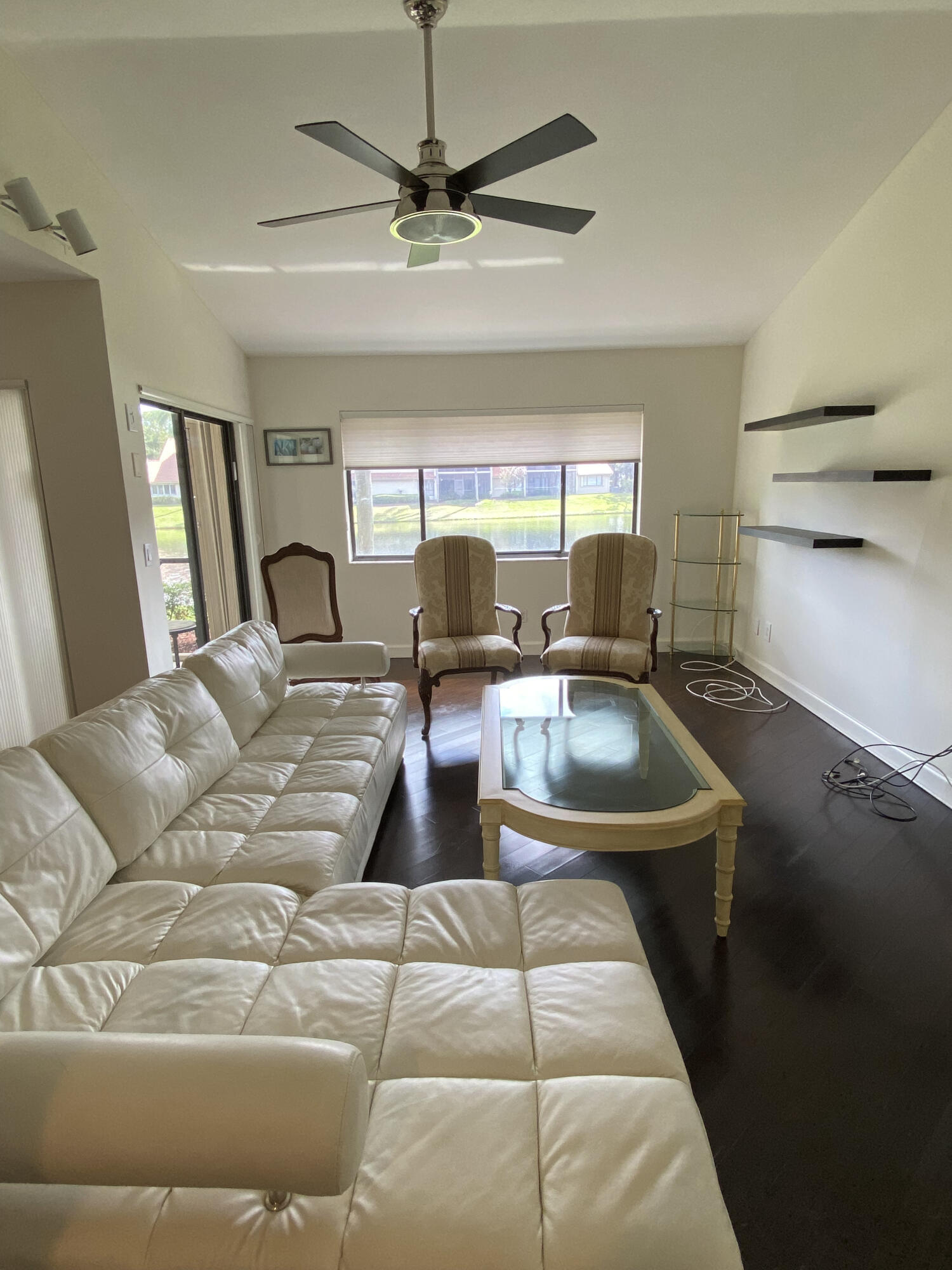 5621 Coach House Circle, Unit D Boca Raton, FL 33486 - Photo 14 of 29 a living room with a couch and a flat screen tv