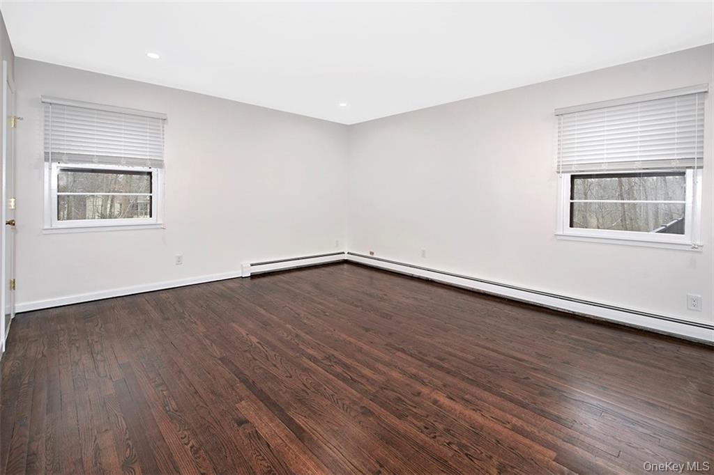 74 Edgewood Road Ossining, NY 10562 - Photo 11 of 23 an empty room with wooden floor and windows