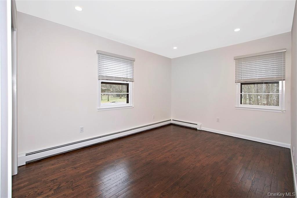 74 Edgewood Road Ossining, NY 10562 - Photo 15 of 23 an empty room with wooden floor and windows