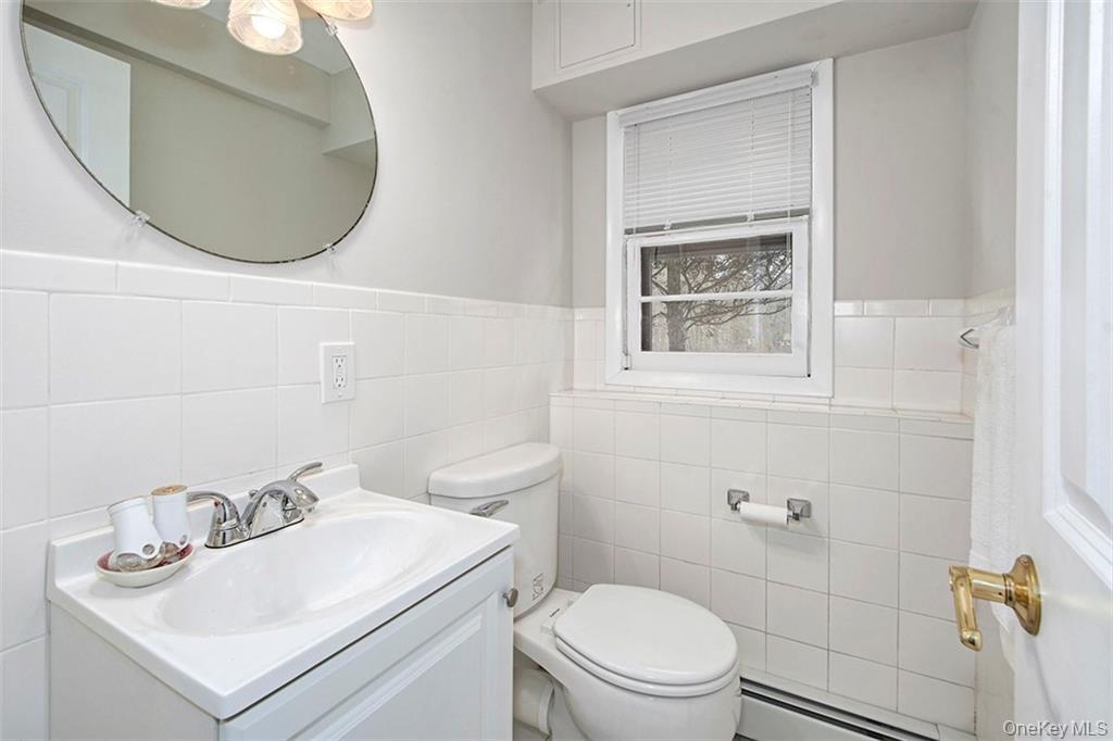 74 Edgewood Road Ossining, NY 10562 - Photo 19 of 23 a bathroom with a sink a toilet and a mirror