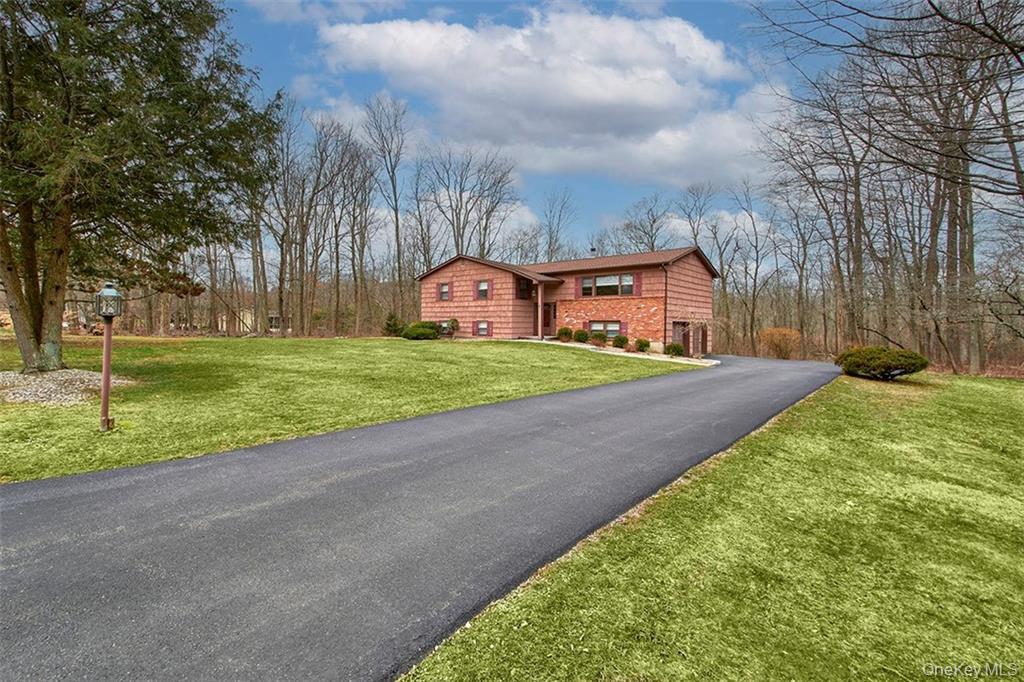 74 Edgewood Road Ossining, NY 10562 - Photo 2 of 23 a view of a house with a yard and large trees