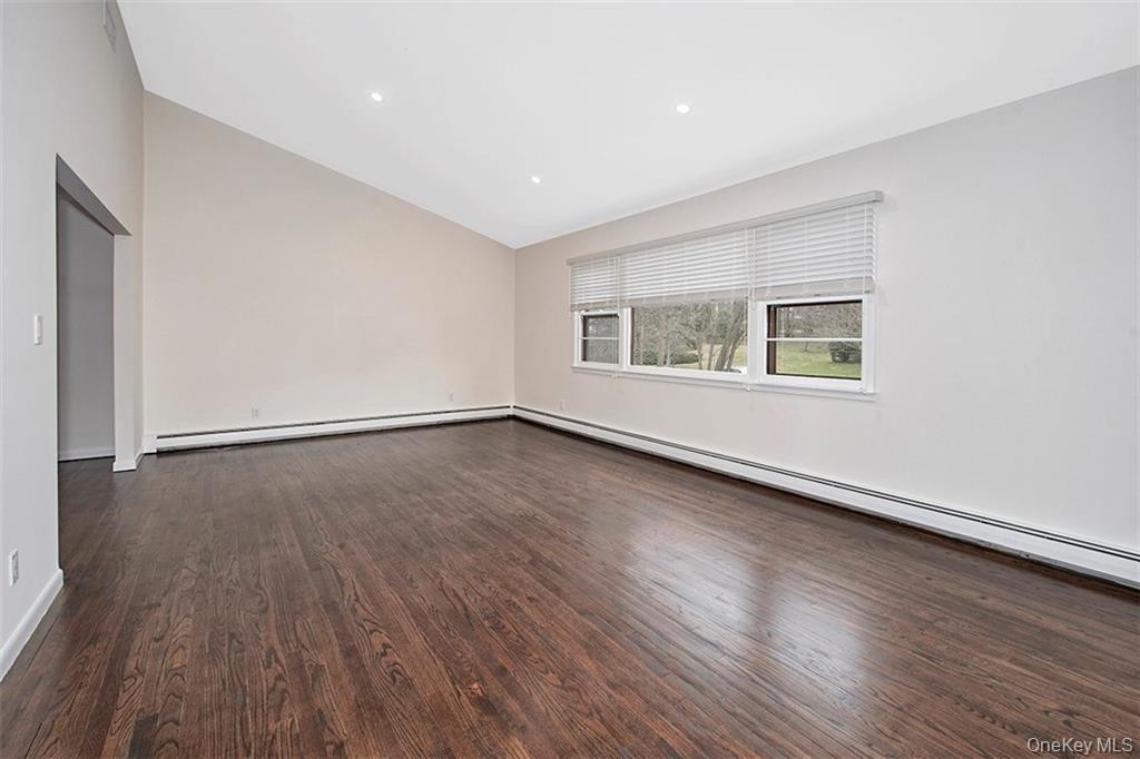 74 Edgewood Road Ossining, NY 10562 - Photo 3 of 23 an empty room with wooden floor and windows