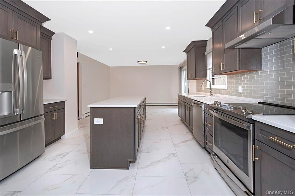74 Edgewood Road Ossining, NY 10562 - Photo 9 of 23 a large kitchen with stainless steel appliances a refrigerator and a sink