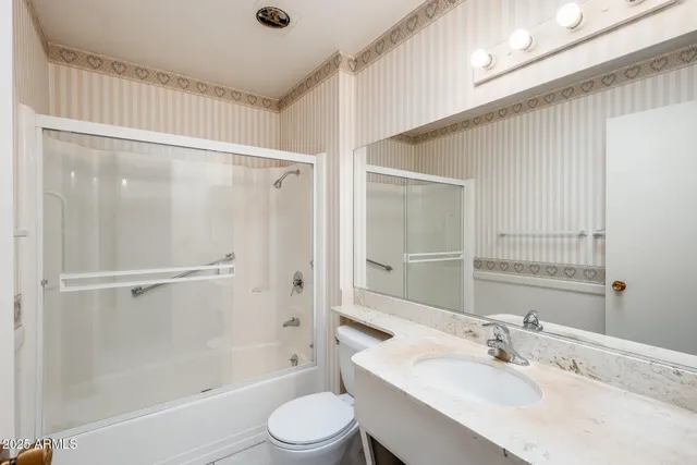 a bedroom with a bed and a ceiling fan