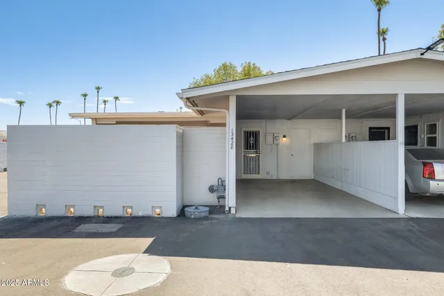 a view of a patio with table and chairs under an umbrella