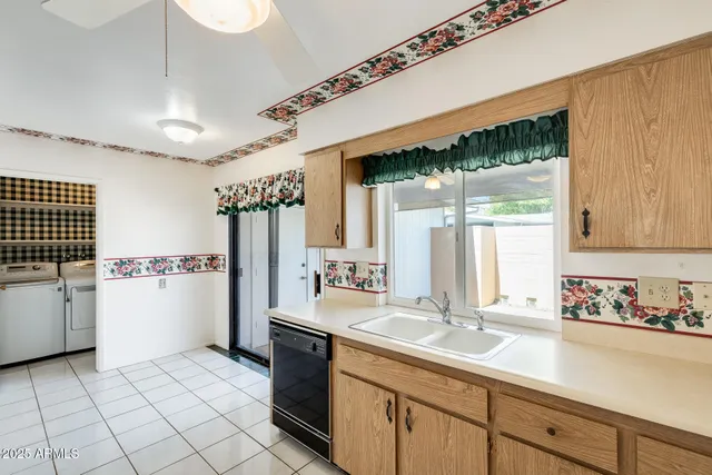 a kitchen with a refrigerator and white cabinets