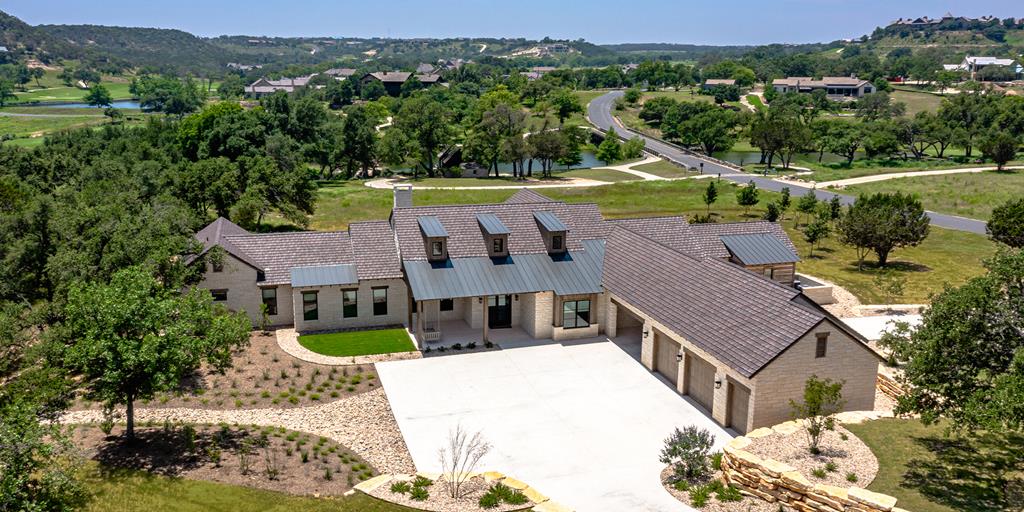 an aerial view of a house with a big yard