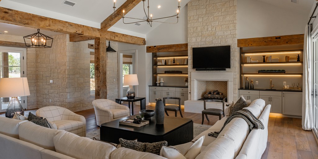 811 Boot Ranch Circle Fredericksburg, TX 78624 - Photo 11 of 34 a living room with furniture a flat screen tv and a fireplace