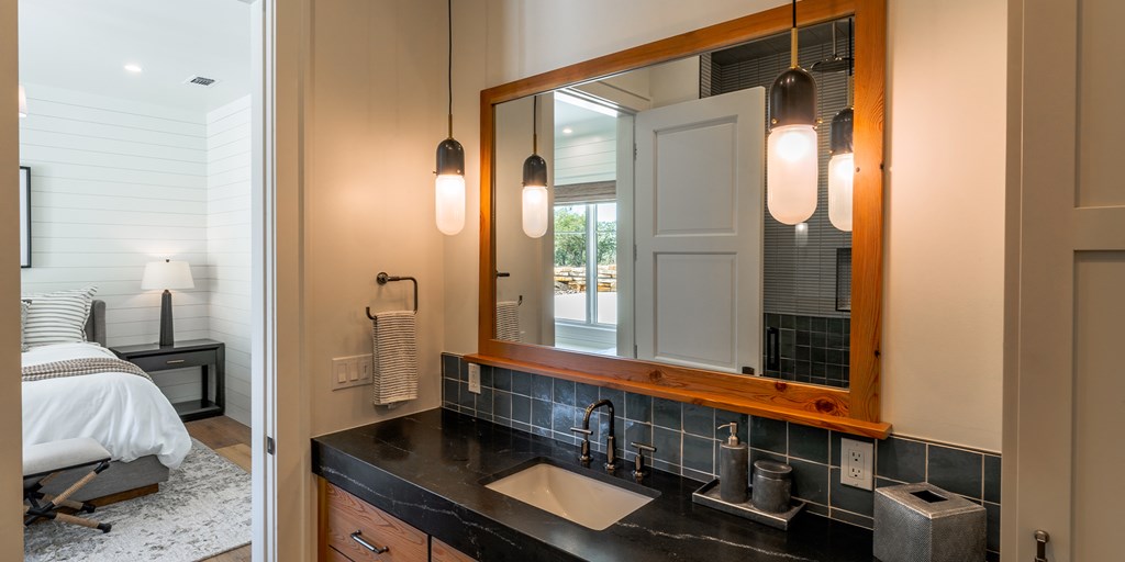 811 Boot Ranch Circle Fredericksburg, TX 78624 - Photo 13 of 34 a en suite bathroom with a sink and a mirror