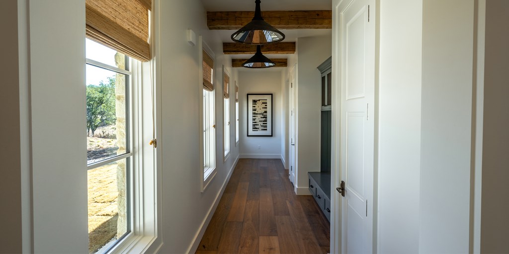 811 Boot Ranch Circle Fredericksburg, TX 78624 - Photo 24 of 34 a view of a hallway view with wooden floor and staircase