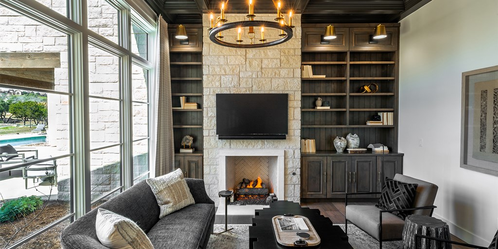 811 Boot Ranch Circle Fredericksburg, TX 78624 - Photo 26 of 34 a living room with furniture a flat screen tv and a fireplace