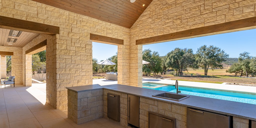 811 Boot Ranch Circle Fredericksburg, TX 78624 - Photo 4 of 34 a porch with a table and chairs