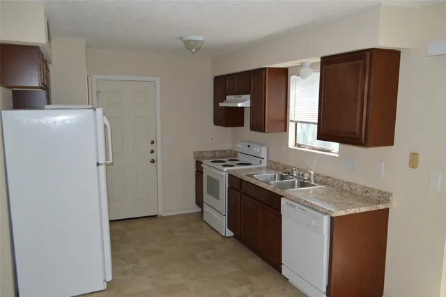 a kitchen with stainless steel appliances granite countertop a stove and a refrigerator