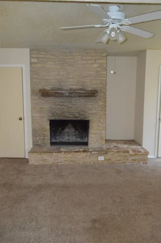 a view of empty room with a fireplace