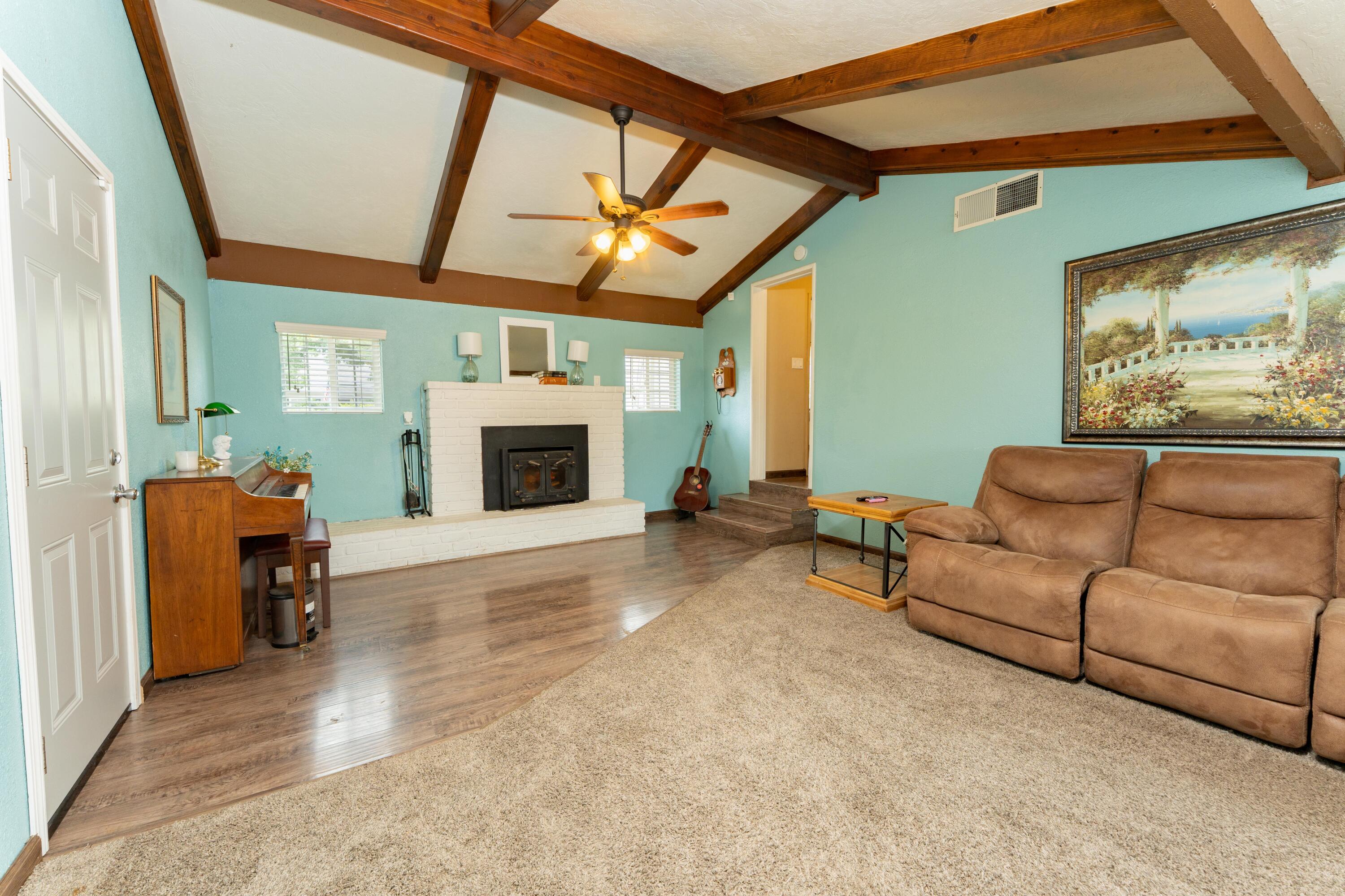 570 North Birch Avenue Reedley, CA 93654 - Photo 26 of 52 a living room with furniture and a fireplace