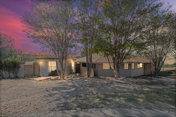 a front view of house with yard and trees