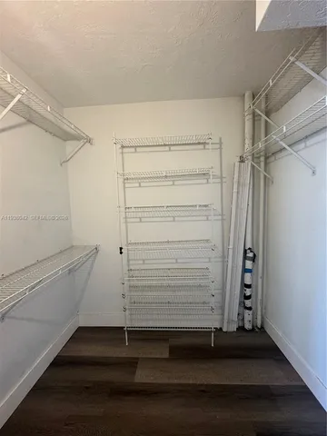 a view of walk in closet with empty racks