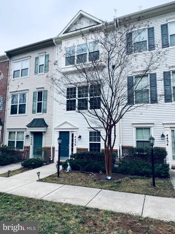 a front view of a residential apartment building with a yard