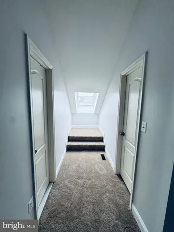 a view of a hallway view with staircase