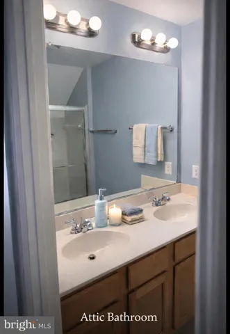 a bathroom with a sink vanity and mirror