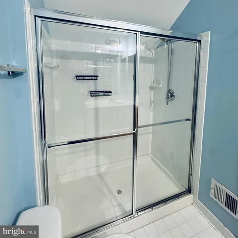 a bathroom with a glass shower door