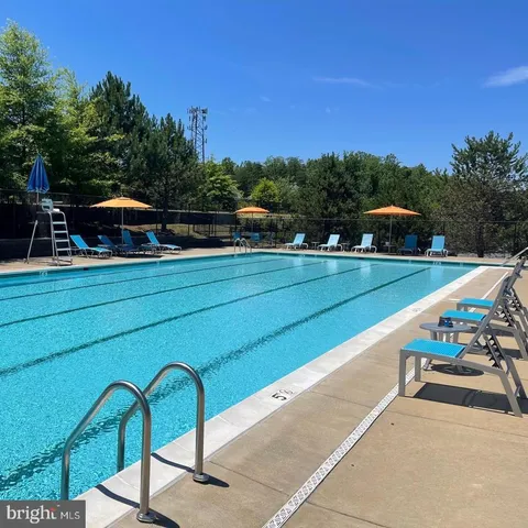 a view of a swimming pool with lounge chairs