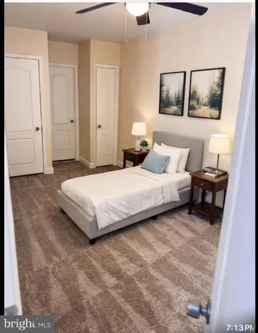 a bedroom with a bed and painting on the wall