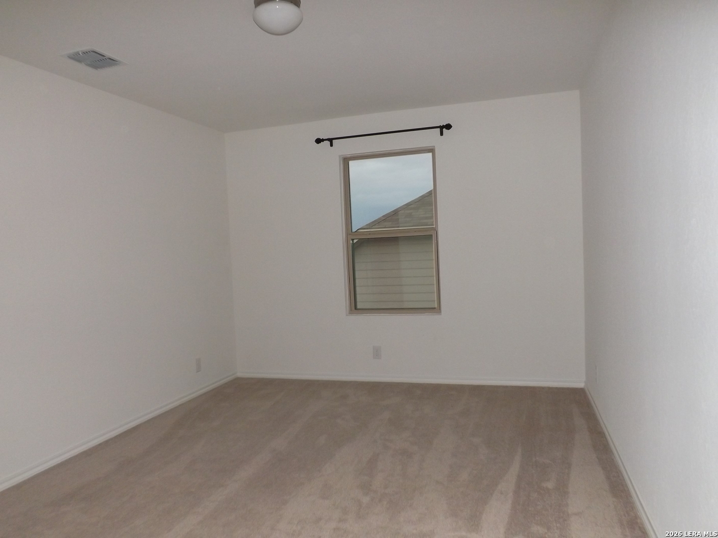 6835 Alaskan Wy. Converse, TX 78109 - Photo 14 of 22 a view of an empty room with a window