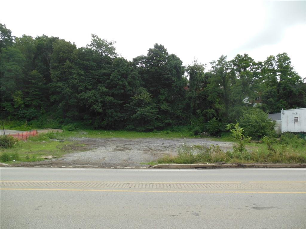 2713-2715 Library Road Overbrook, PA 15234 - Photo 2 of 8 a view of a yard and a car parked on the road