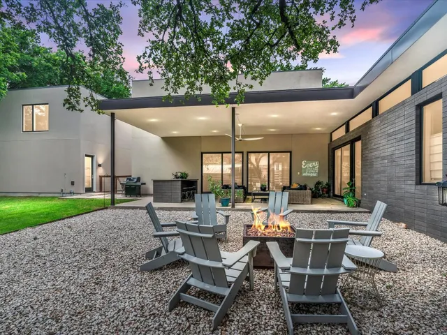 a view of a patio with table and chairs and potted plants