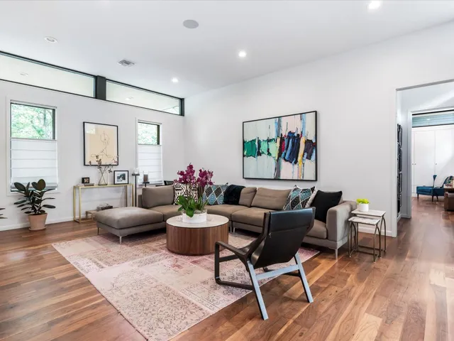 a living room with furniture and wooden floor