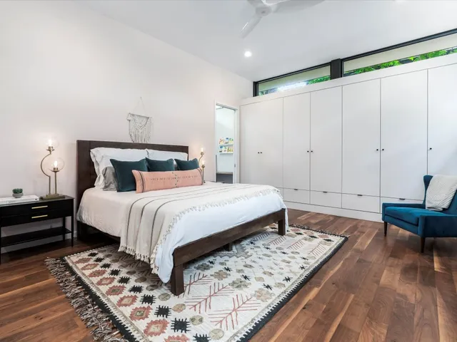 a bedroom with a bed and wooden floor