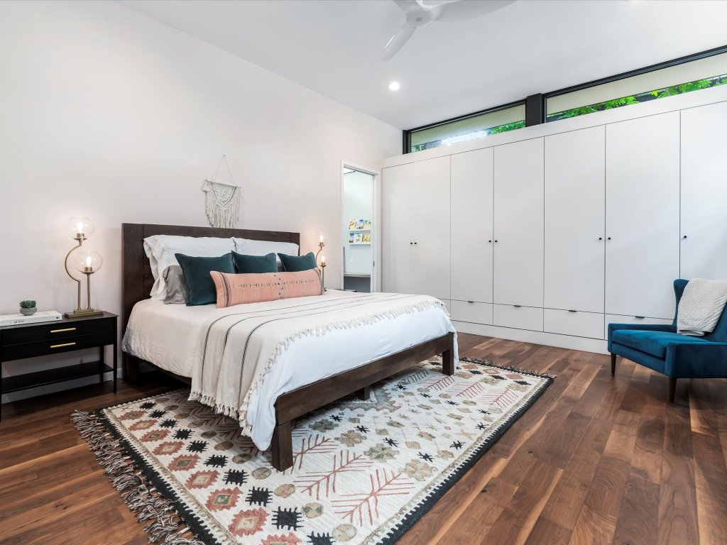 1703 Dexter Street Austin, TX 78704 - Photo 17 of 38 a bedroom with a bed and wooden floor