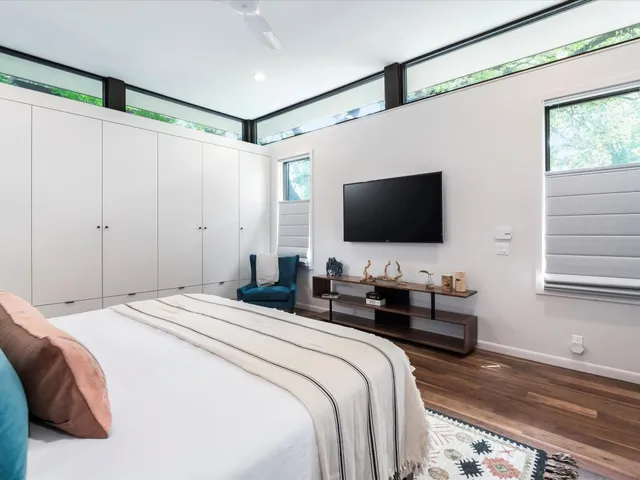 a bedroom with a bed and a flat screen tv