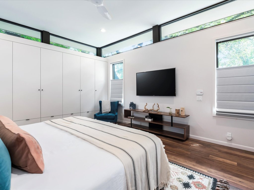 1703 Dexter Street Austin, TX 78704 - Photo 18 of 38 a bedroom with a bed and a flat screen tv