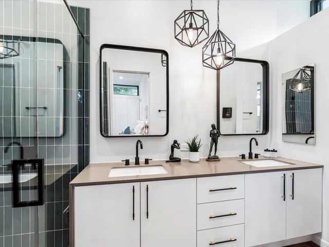 a bathroom with double sink and a mirror