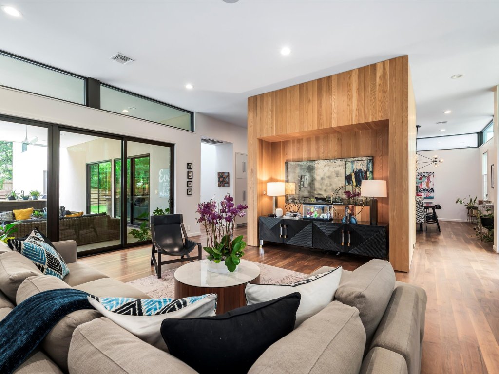 1703 Dexter Street Austin, TX 78704 - Photo 2 of 38 a living room with furniture potted plant kitchen view and a large window