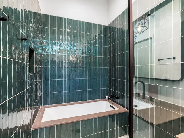 a bathroom with a bathtub and a shower